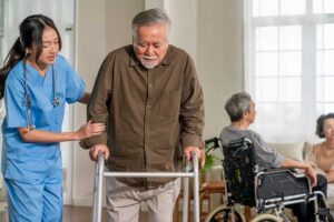 Older adults participate in a supervised music and gentle movement session in a bright community room.