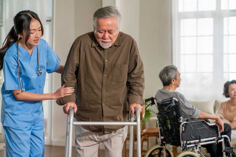 Older adults participate in a supervised music and gentle movement session in a bright community room.